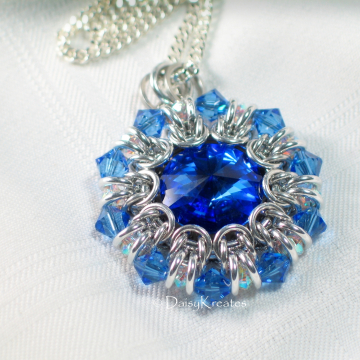 Clear and blue bicone beads form pointy outer rim as crystal ruffle